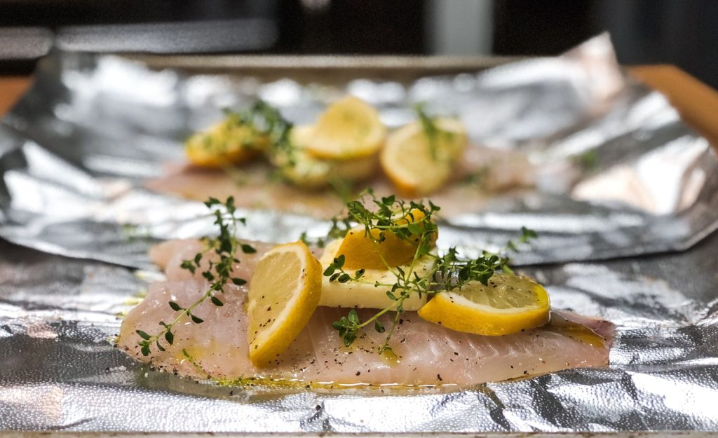 a salmon fillet topped with lemon slices
